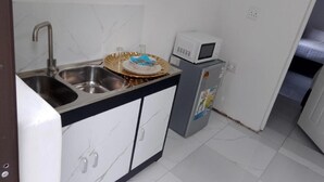A compact kitchen with a sink, a microwave, and a small refrigerator. - Duminy Guest Lodge (Duminy Street)