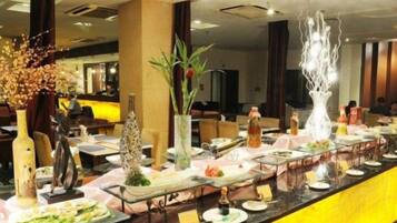 A buffet setup with various dishes and decorative elements.