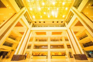 A multi-level atrium with a glass ceiling, multiple floors, and a central open space. - Guanghua International Hotel (Nantong)