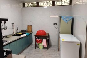A compact kitchen with a sink, stove, and a refrigerator.