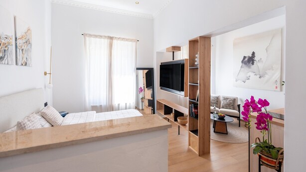 A modern living room with a flat-screen TV, wooden furniture, and a large painting on the wall. - Apartment in Koblenz Near Deutsches Eck (Koblenz)