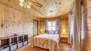 A wooden cabin bedroom with a bed, nightstands, a ceiling fan, and built-in storage. - Mtn & Golf Course Views: Payson Retreat! (Payson)