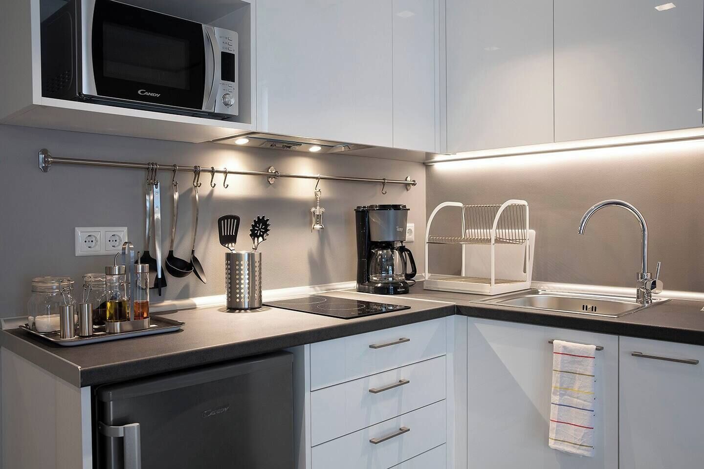 Fridge, microwave, coffee/tea maker, cookware/dishes/utensils