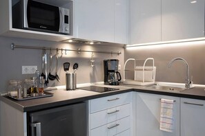 Fridge, microwave, coffee/tea maker, cookware/dishes/utensils