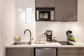 Fridge, microwave, coffee/tea maker, cookware/dishes/utensils