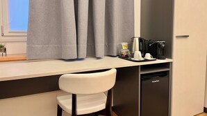 A modern kitchenette with a coffee maker, a small refrigerator, and a chair. - Dimore Diffuse R H (Rende)