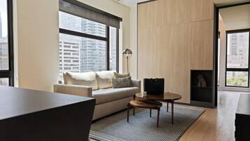 A modern living room with a sofa, coffee table, and a lamp.