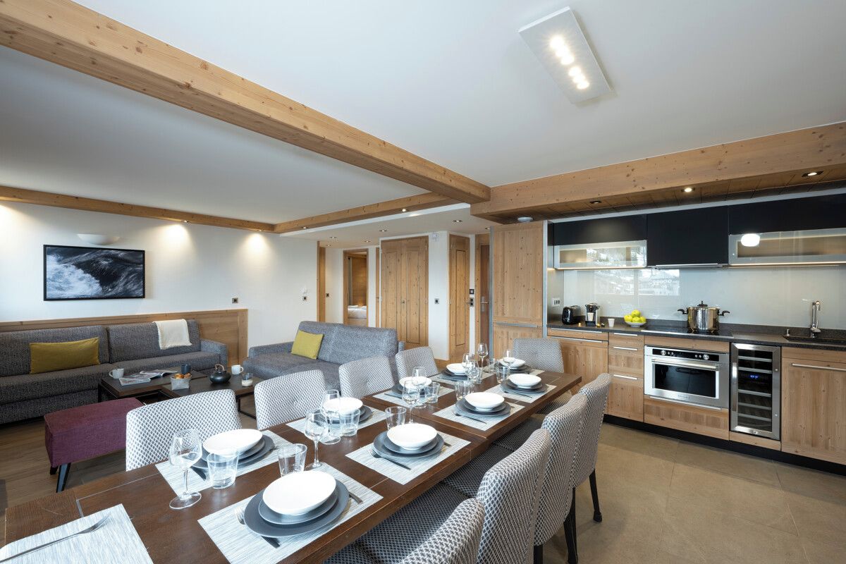 A modern kitchen with wooden cabinets and a built-in oven.
