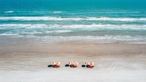A beach with a row of beach chairs and umbrellas. - Stella Maris 160 Tai-e (Port Aransas)