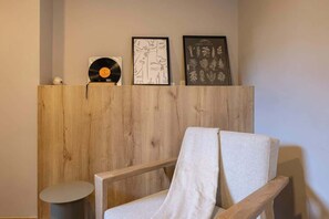 A wooden partition with a vinyl record and framed artwork.