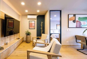 A modern waiting area with a reception desk, seating, and artwork on the walls. - Digital Nomad Paradise ~1BR unit in Manila’s Heart (Medellín)