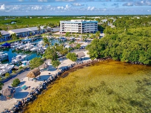 A resort with a marina, clear waters, and a building with multiple balconies. - Spectacular Ocean-Marina Views - Free Kayaks Pickleball (Key Largo)