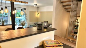 Una cocina moderna con encimera de madera, luces colgantes y un armario empotrado.