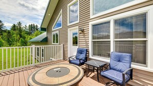 A deck with a round table and two chairs, a white railing, and large windows. - Mtn-View Home 6 Mi to Jay Peak Resort: Fish & Hike (Montgomery Center)