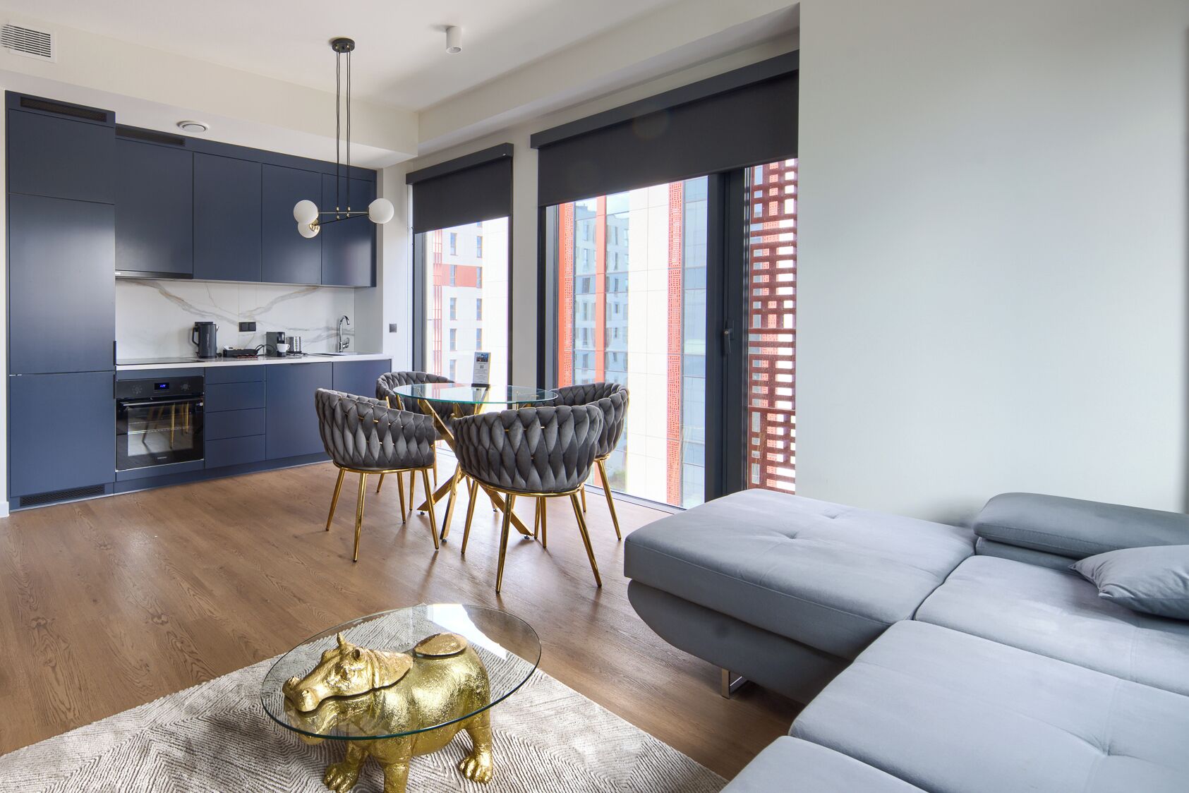 Un appartement moderne comprenant un coin repas, une cuisine et un salon.
