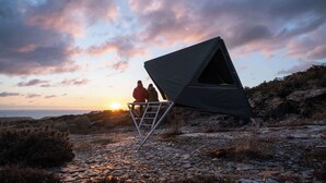 A tent set up on rocky terrain with a view of the sunset. - The K-Tent 2 Summary: (Tintagel)