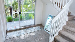 A staircase with white railings leading to a landing.
