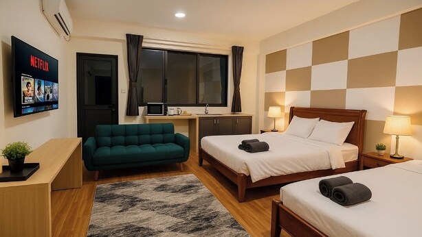 A hotel room with two beds, a desk, a TV, and a sofa. - 1-bedroom Studio aprtmt with AC, WiFi, Washer,Dryer located 5min Apia, on mainrd (Apia)
