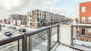 A residential area with modern multi-story buildings, a snow-covered street, and parked cars. - Holiday retreat in Toronto (Toronto)