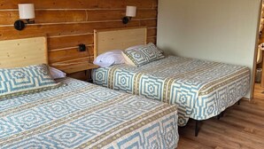 A cozy room with two beds, wooden walls, and a ceiling fan. - Angler Cabin-Modern Comfort in the Last Frontier (For families or casual travelers) (Tok)