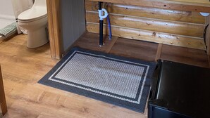 A compact bathroom with a sink, mirror, and toilet. - Angler Cabin-Modern Comfort in the Last Frontier (For families or casual travelers) (Tok)