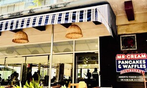 A restaurant named "Mr. Cream Pancakes & Waffles" with a signboard and awnings.