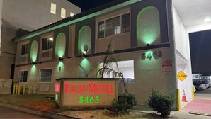 A motel with a sign reading 'PALM MOTEL 8463' and a 'SLOW' traffic sign. - Palm Motel - Rosemead (Rosemead)