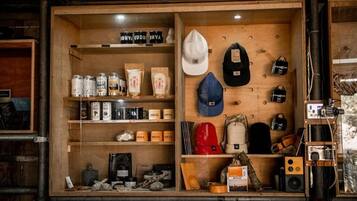 A wooden display case with various items including hats, bags, and containers.