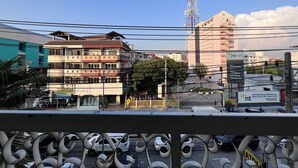 A cityscape with buildings, a prominent tower, and a signboard. - Green Hotel (Pattaya)