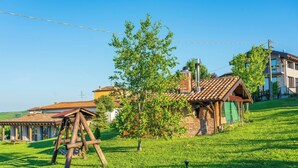 A rustic house with a sloped roof, a chimney, and a small tree in the front yard. - Villa 'Casa Vacanze Elios B' with Mountain View, Wi-Fi and Air Conditioning (Unknown)