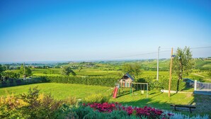 A rural landscape with a small building, a playground, and a clear view of the countryside. - Villa 'Casa Vacanze Elios B' with Mountain View, Wi-Fi and Air Conditioning (Unknown)