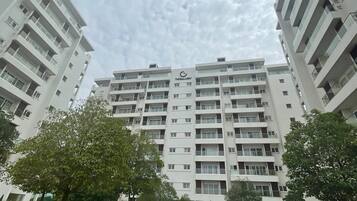 A multi-story residential building with a flat facade, balconies, and a sign reading "THE GALLERY".