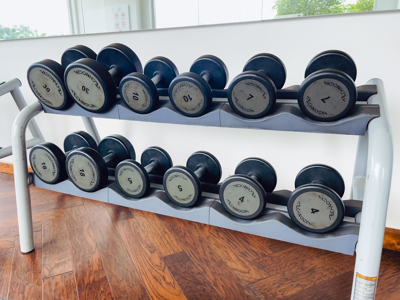 A rack of dumbbells with weights ranging from 4 to 30 pounds.
