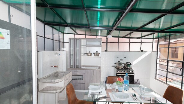 A compact kitchen with a gas stove, a sink, and a small countertop.