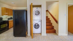 A kitchen with a refrigerator, oven, and washing machine. - Charming 2-bedroom apartment with AC, WiFi in fabulous Saint John's (Saint John's)