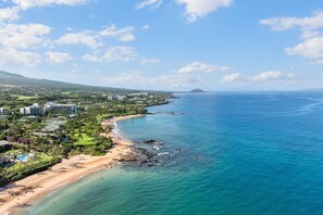 A coastal resort with beachfront properties, a golf course, and a view of the ocean.