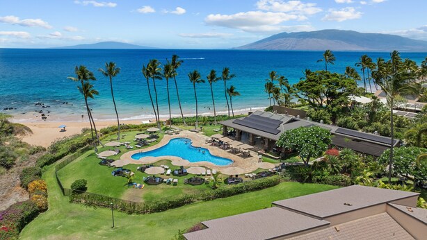 A resort with a swimming pool, beach, and ocean views.