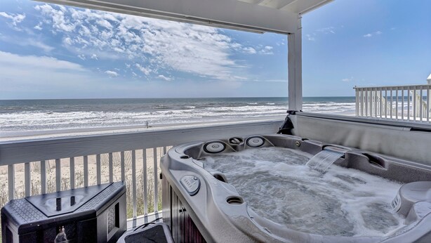 A hot tub on a balcony with a view of the beach and ocean. - Oceanfront Paradise with Amazing Views, Hot Tub! (Surf City)
