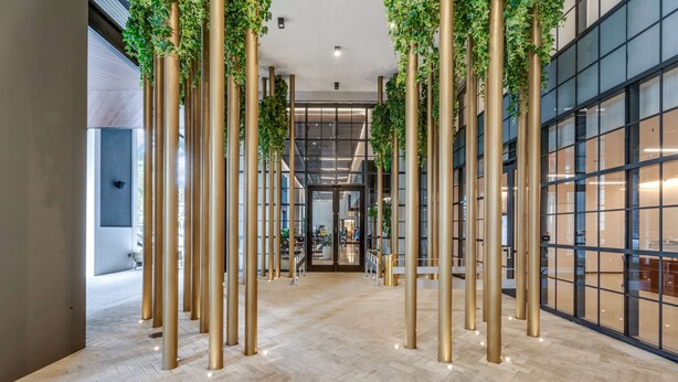 A modern interior with a central corridor flanked by glass walls and a patterned floor. - Limoncello Spritz - Central Miami Pool Gym Spa (Miami)