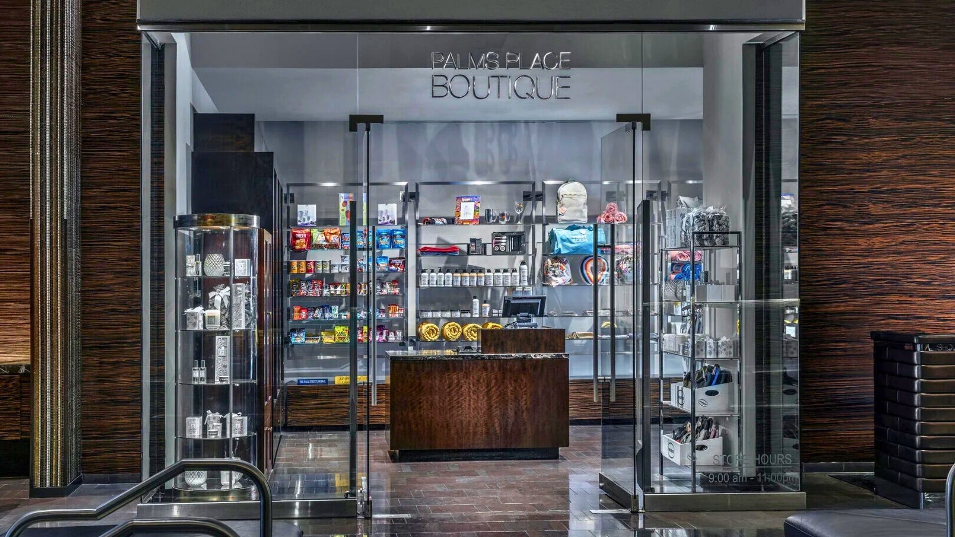 The entrance of a boutique with glass display cases and shelves of products.