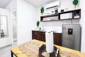 A modern kitchen with a refrigerator, microwave, and sink. - The Fern Studio: Cozy & Modern for Nature Lovers (Jaco)