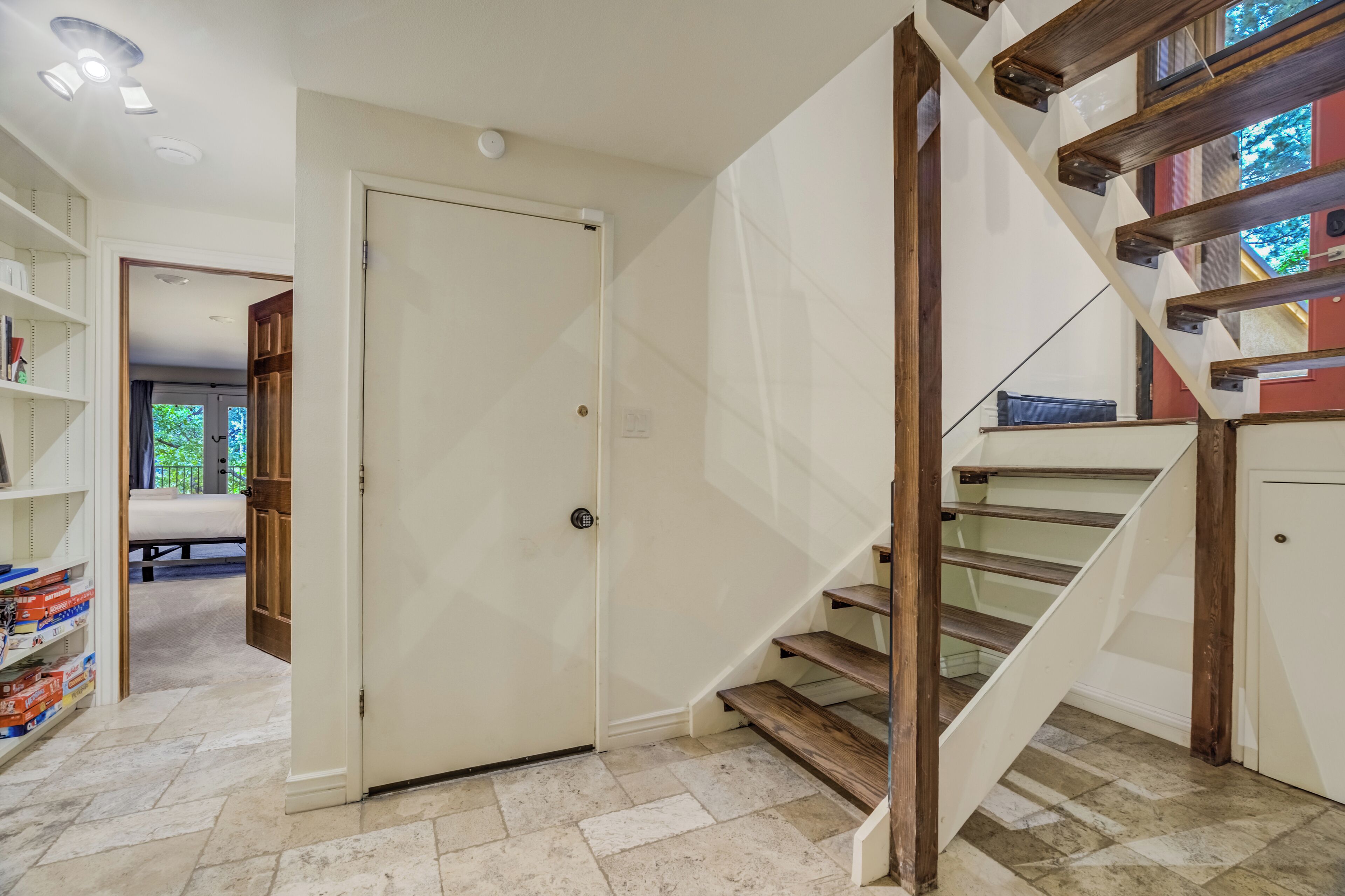 A staircase with wooden steps and a white door.