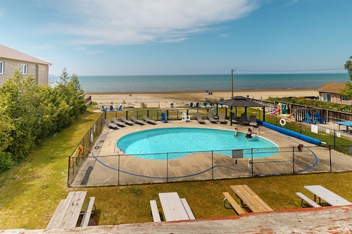 Lakefront condo steps to the beach with pool, and fireplace