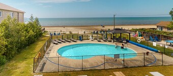 Lakefront condo steps to the beach with pool, and fireplace