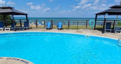 Lakefront condo steps to the beach with pool, and fireplace