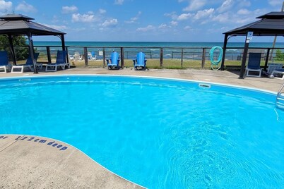 Lakefront condo steps to the beach with pool, and fireplace