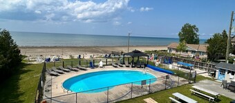 Lakefront condo steps to the beach with pool, and fireplace