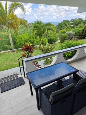 Outdoor dining - Cozy Studio with Seaview. Beach nearby/ On-site car rental/ Very comfortable bed (Crosbies)