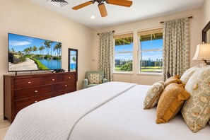 Your second bedroom offers comfortable sleeping space with coastal-inspired decor and a mounted flat screen TV. HLI-12A