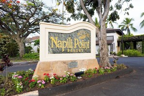 A sign for Napili Point Resort with a stone base and a marble plaque. - Napili Point | Oceanfront 5 BR, Sleeps 14 | Car Incl. w/ 6+ Nights | NAP ML-1301 by KBM (Lahaina)
